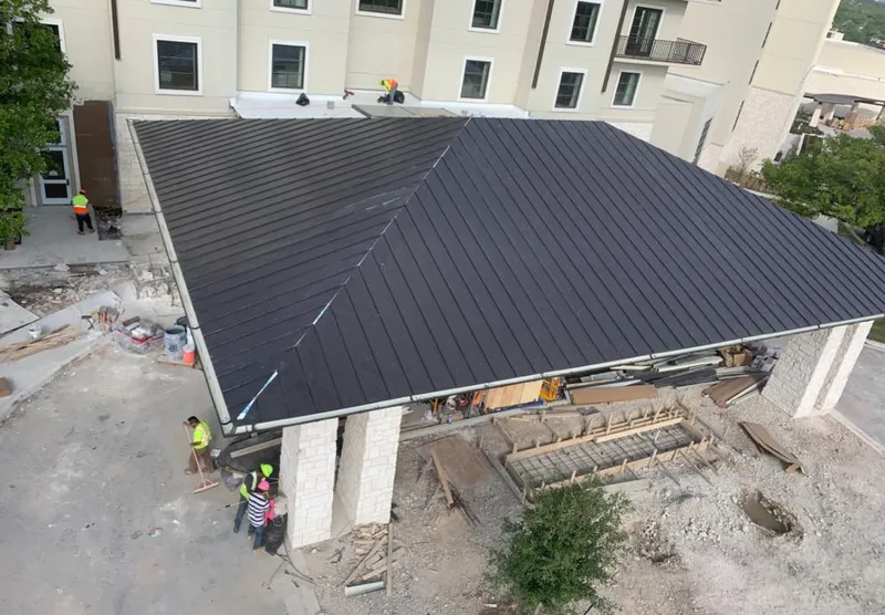 Metal roofing installation team working on a commercial building in Savannah
