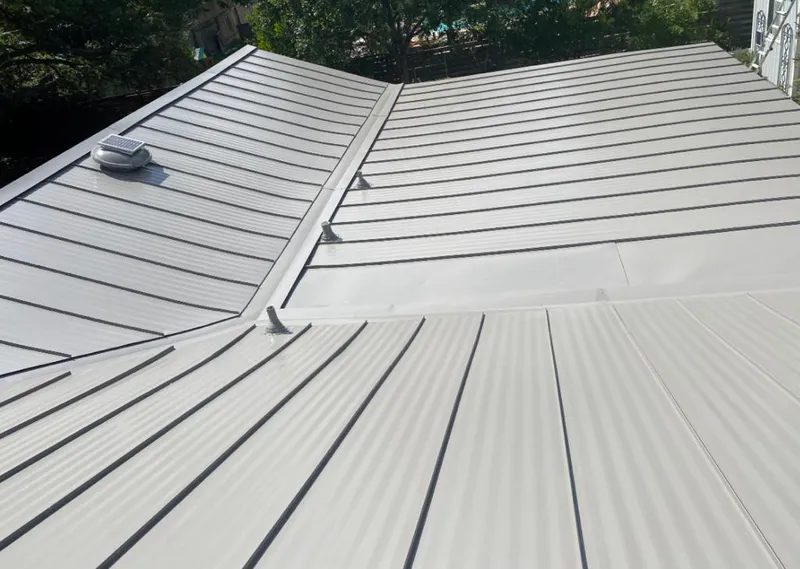 Solar attic fan installed on a metal roof for Roof Ventilation in Savannah